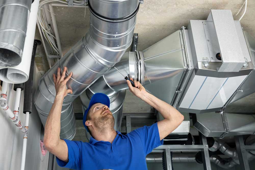 technician Cleaning HVAC system