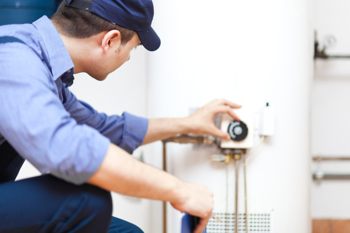 Technician servicing a water heater.